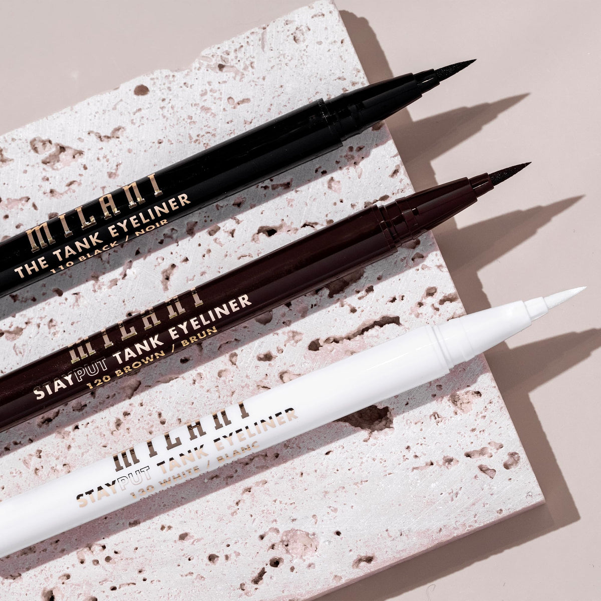 Milani swatch stroke of brown 120 on skin showing rich pigment payoff