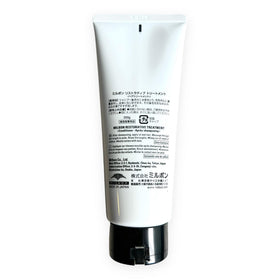 Milbon treatment applied to damp hair in bathroom, demonstrating easier detangling benefit