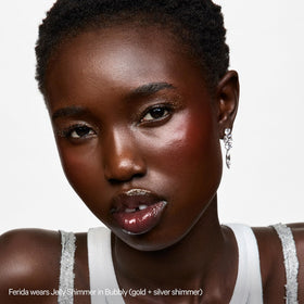 Milk Makeup lip detail with shimmer stick showing lightweight shine and comfortable wear