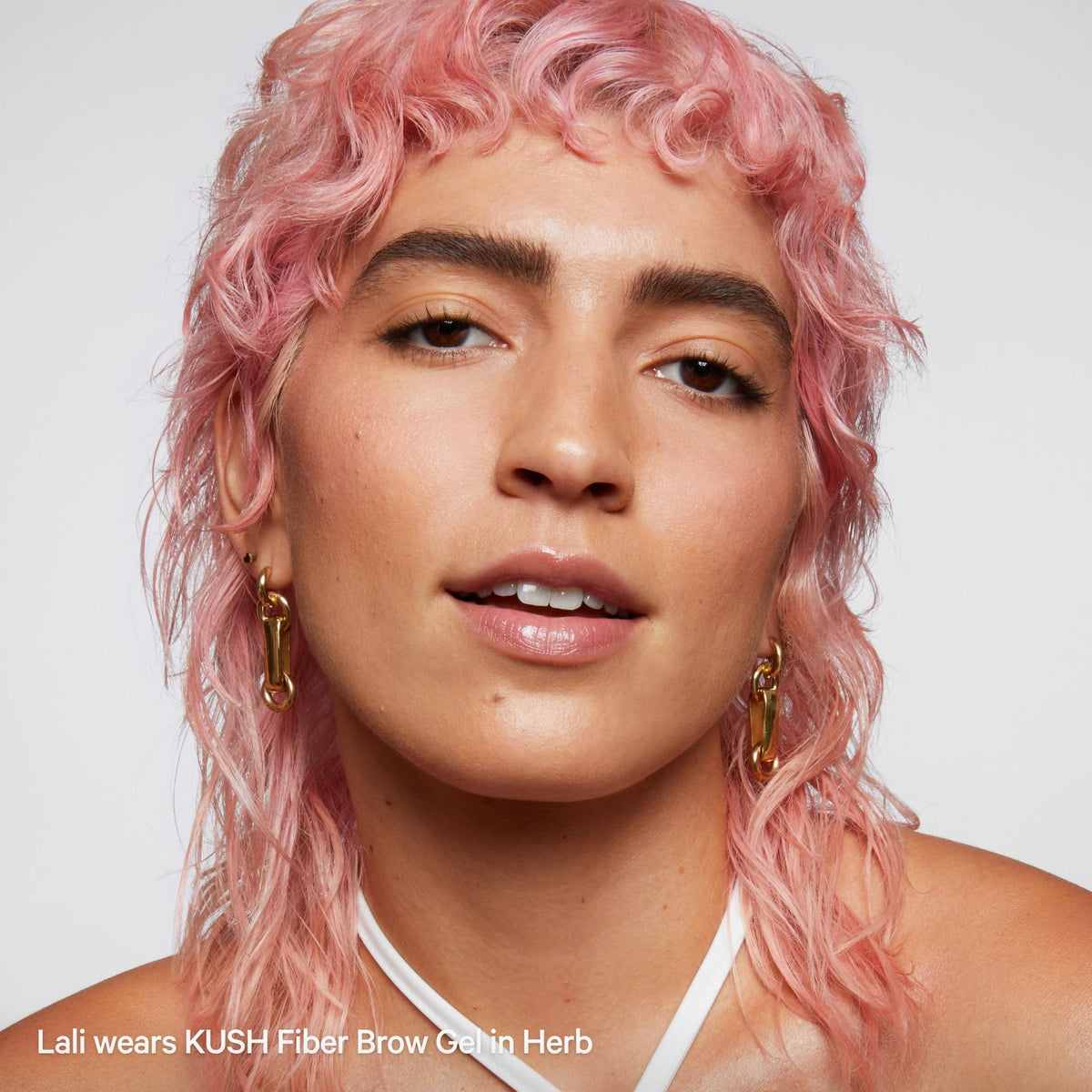 Milk Makeup KUSH in street-style scene showing long-wear, lived-in look