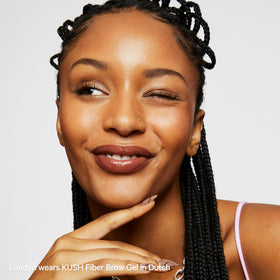 Milk Makeup lifestyle image of dressed model with groomed brows for confident look