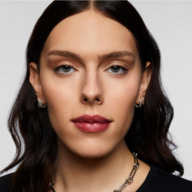 Milk Makeup mist on model face giving matte finish and blurred pores