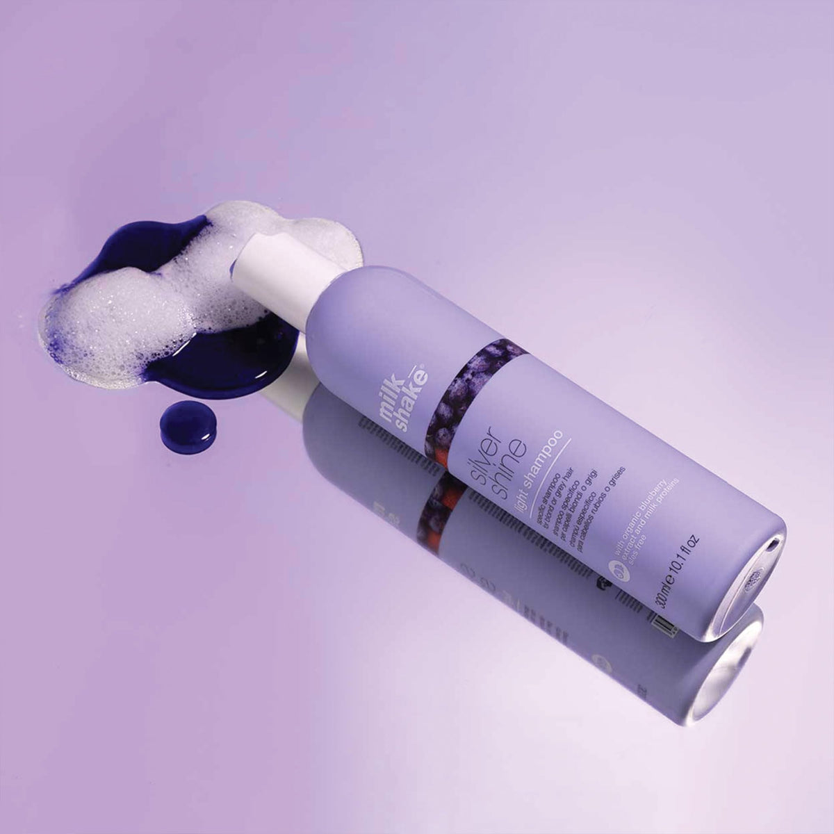 milk_shake product in hand above wet blonde hair showing targeted brassiness control