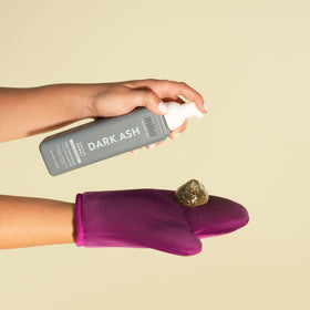 MINETAN BODY.SKIN bottle in hand shows 6.7 fl oz scale and travel convenience