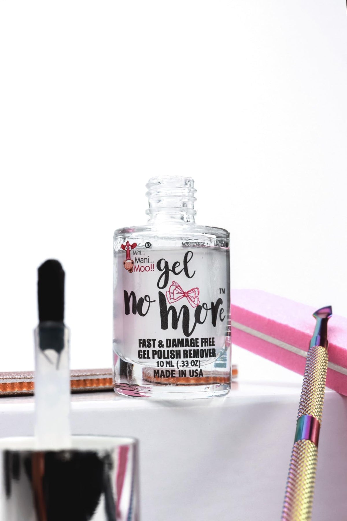 Mini Mani Moo size comparison 10ml next to coin highlighting travel-friendly size
