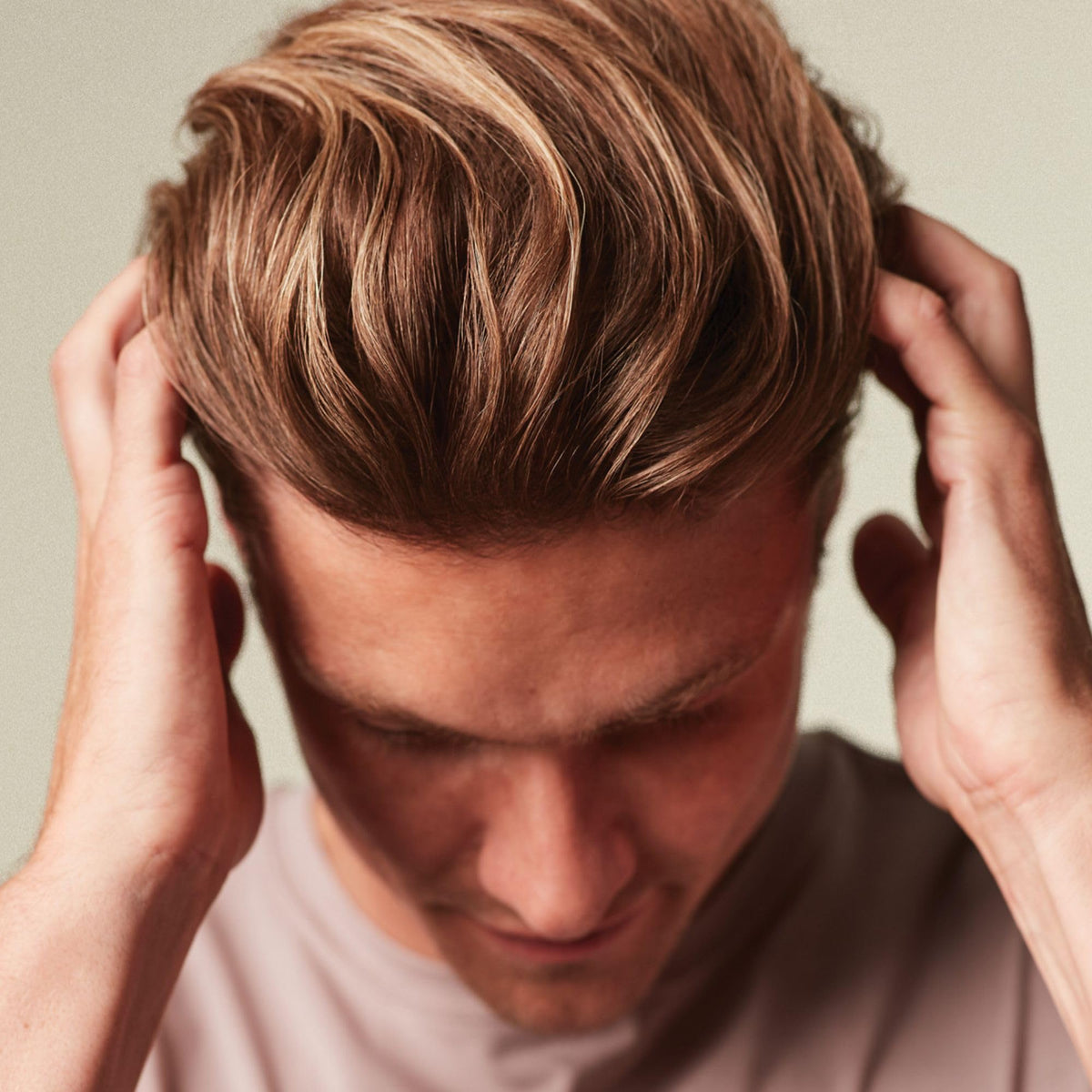 MITCH cream on fingertips, shows spreadable formula for quick volumizing benefit