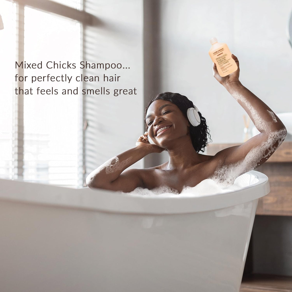 Mixed Chicks 33oz bottle beside hand, size comparison highlighting long-lasting supply