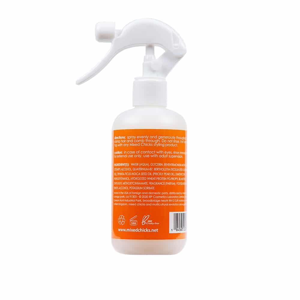 Mixed Chicks base coat misting onto hair demonstrating even pre-styling coverage