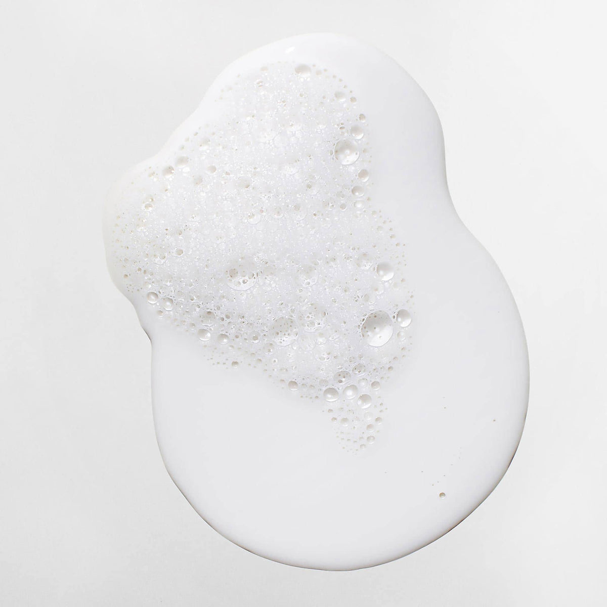 Mizani shampoo being applied in shower demonstrating proper usage