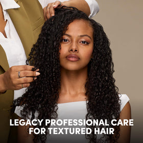 Mizani being applied to scalp under braids demonstrating targeted relief and freshness