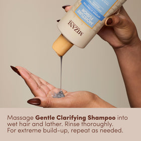 Mizani bottle next to hand for scale and travel suitability