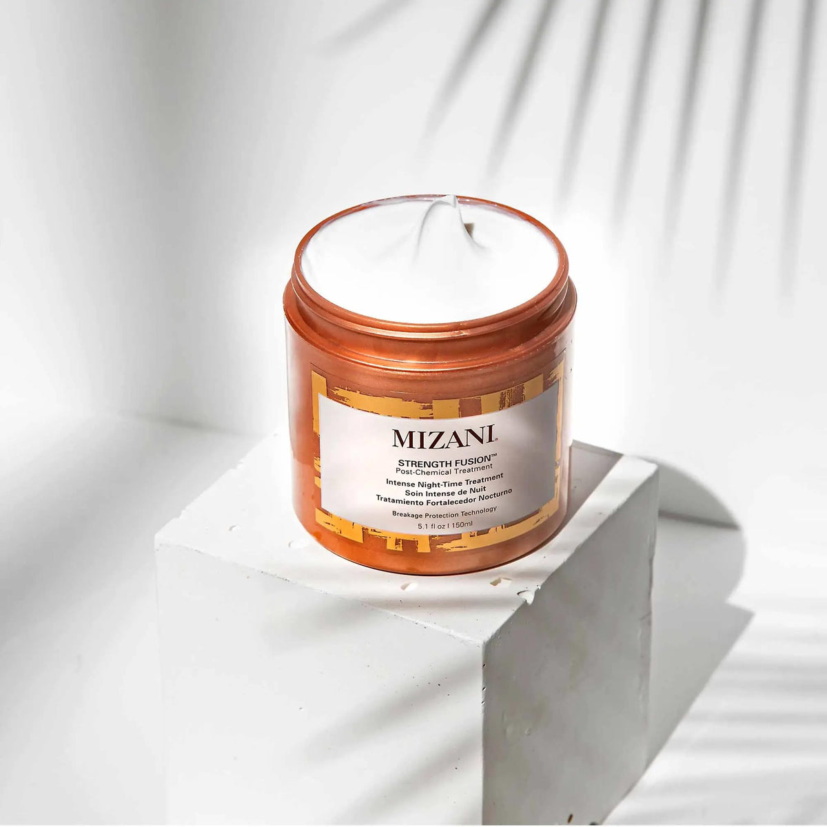 Mizani Strength Fusion applied to curly hair overnight protecting against breakage
