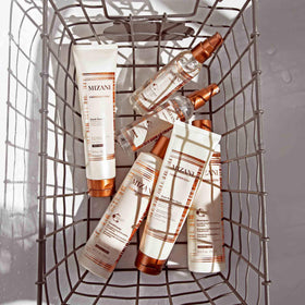 Heat styling session with Mizani serum for smoother, shinier blowout