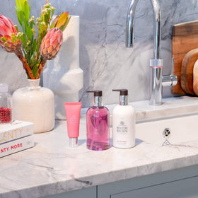 Molton Brown hand wash in use on hands showing effective clean and fresh scent benefit