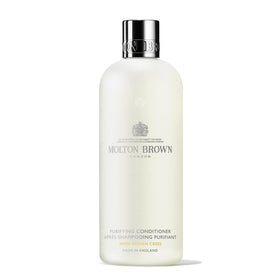 Molton Brown front bottle view showing label and elegant packaging for premium gifting