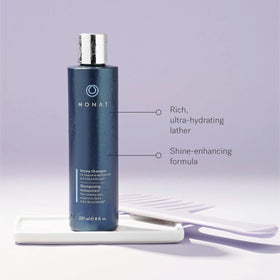 MONAT Renew Shampoo bottle in hand for scale and easy usage indication