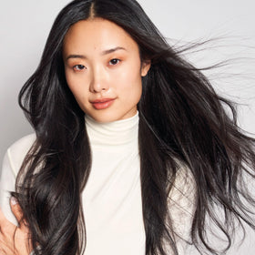 MONAT shampoo bottle styled on bathroom shelf for lifestyle appeal