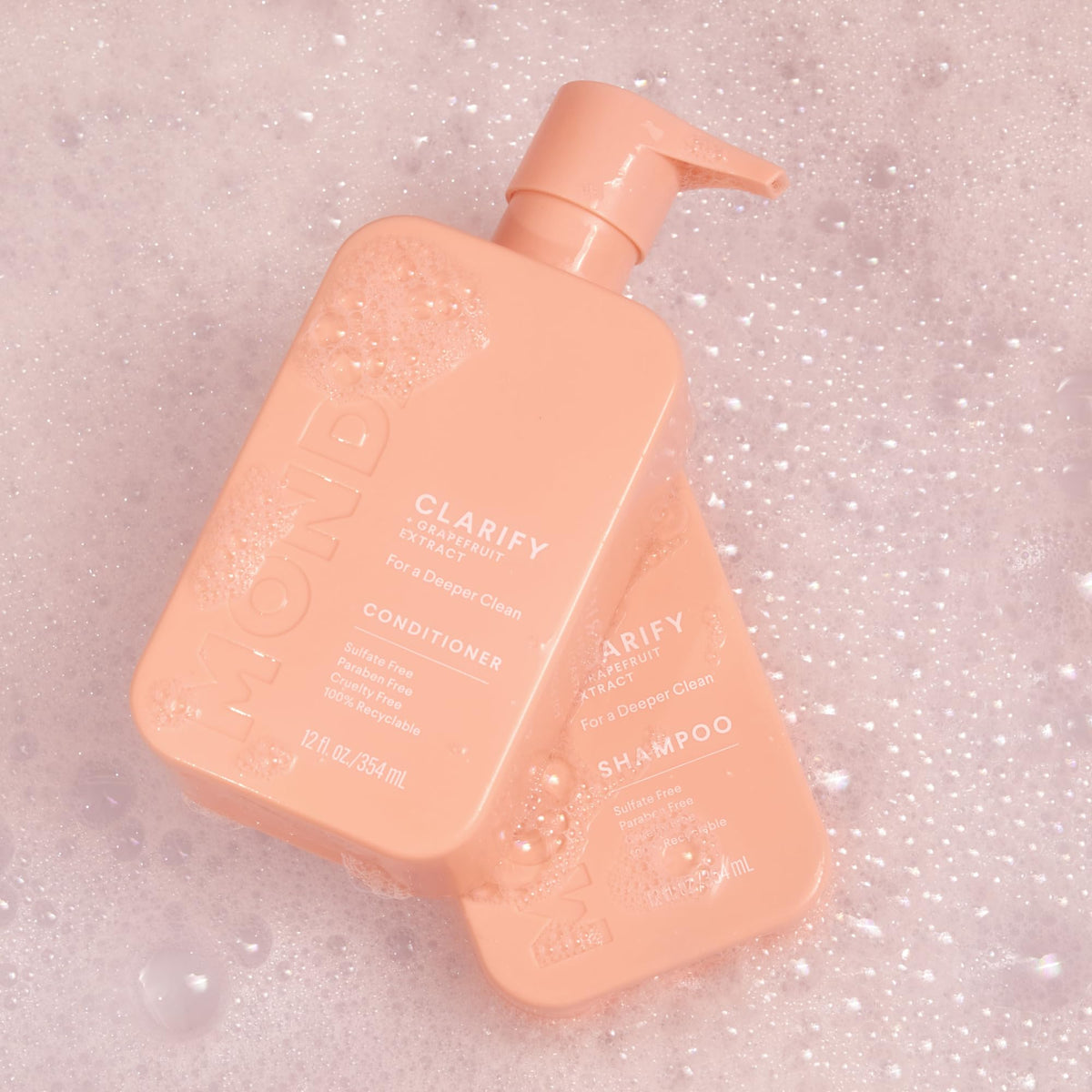 MONDAY HAIRCARE bottles on bathroom shelf communicating recyclable packaging and style