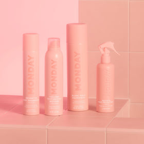 MONDAY HAIRCARE on bathroom shelf with styling tools conveying daily routine benefit