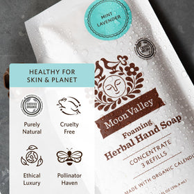 Moon Valley Organics pouch beside dispenser to show refill capacity