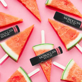 Moroccan Magic tube beside lipstick showing compact size and versatile use