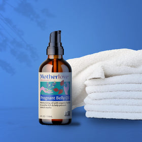 Motherlove being massaged onto a pregnant tummy for soothing hydration