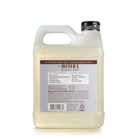 Pouring Mrs. MEYER'S lavender refill into a pump dispenser for economical refills and reduced waste