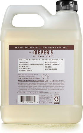 Mrs. MEYER'S pouring refill into dispenser to demonstrate simple, low-waste refill process