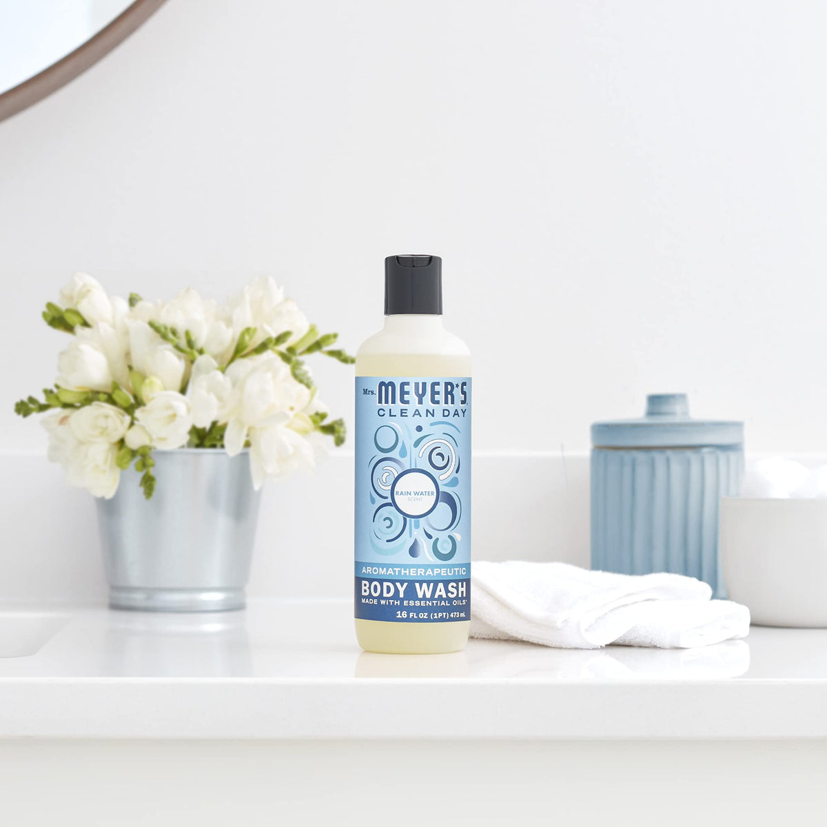 Mrs. MEYER'S bottle on bathroom shelf in styled shower showing subtle fragrance coordination