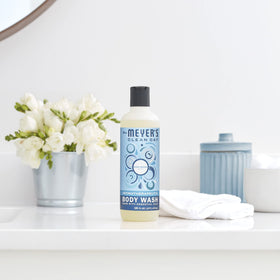 Mrs. MEYER'S bottle on bathroom shelf in styled shower showing subtle fragrance coordination