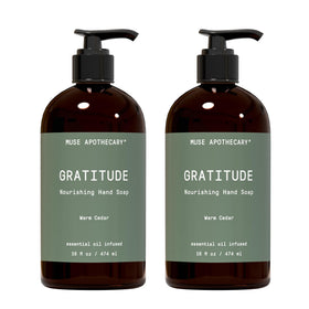 Muse Apothecary front packaging showing Warm Cedar 16 oz bottle and calming scent benefit