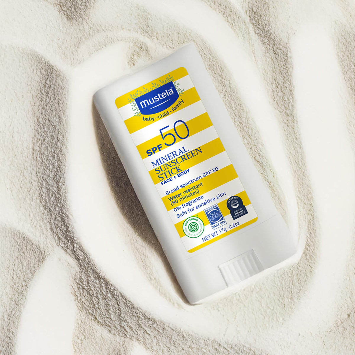 Mustela sun stick inside a beach bag indicating convenience for on-the-go protection
