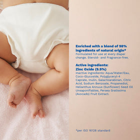 Mustela tube beside baby sock showing product scale and travel-friendly size
