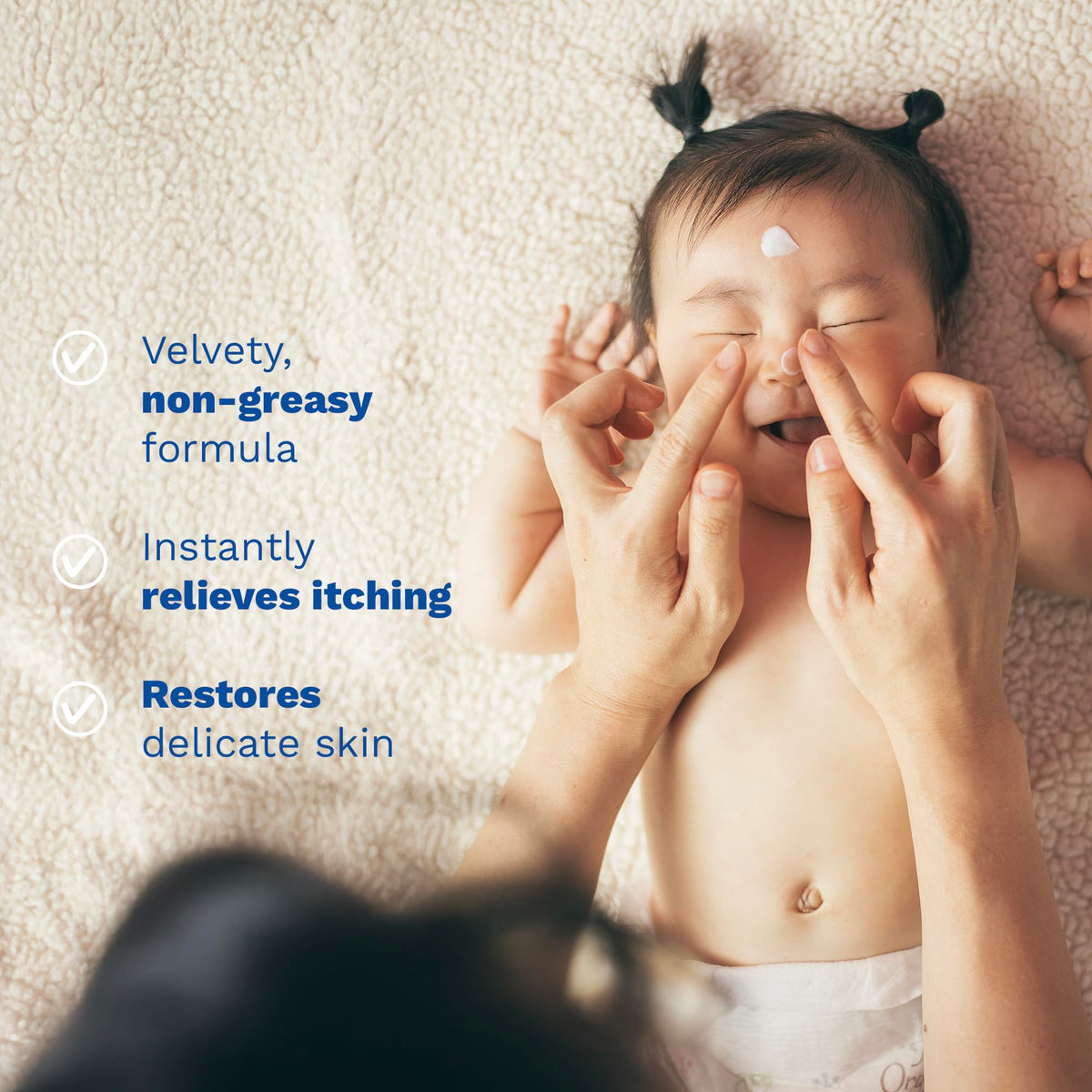 Mustela Stelatopia gently applied to eyelid area showing delicate use