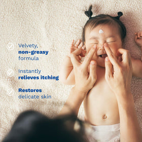 Mustela Stelatopia gently applied to eyelid area showing delicate use