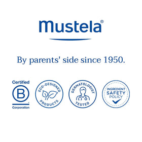 Mustela bottle near water illustrating 80 minute water resistance benefit