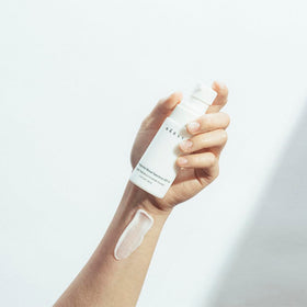 NAELI size shown in hand to illustrate 1.4 oz travel-friendly convenience