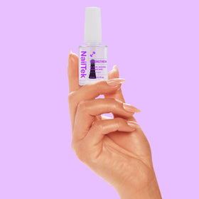 Nail Tek kit beside a quarter for scale showing travel-friendly 0.5 fl oz sizes