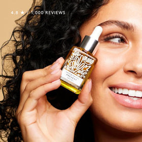 Naked & Thriving recyclable glass bottle emphasizing eco-friendly packaging benefit