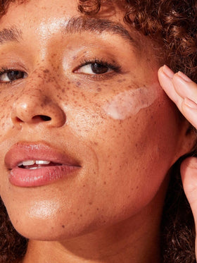Naked Sundays spreading serum on cheek demonstrating lightweight feel