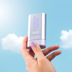 Naked Sundays sun stick being used at the beach for fast outdoor SPF touch-ups