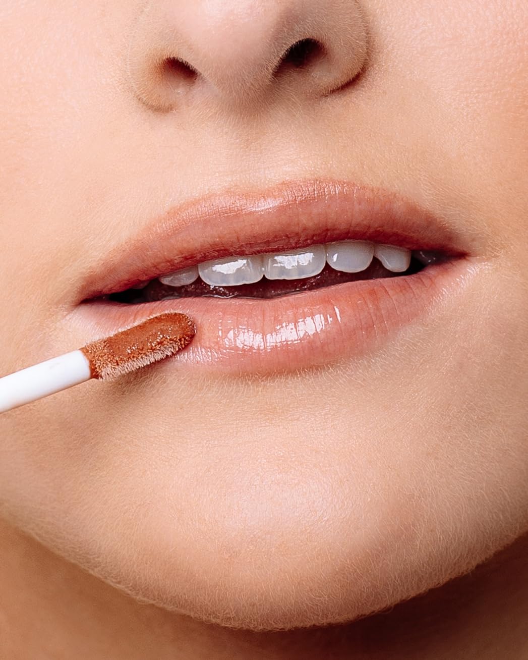 Naked Sundays lip oil texture drop highlighting glossy, hydrating finish