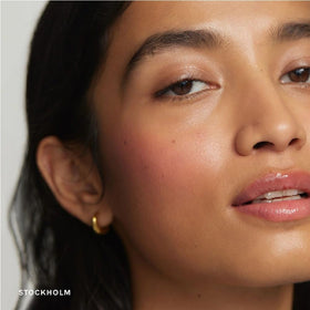 NAPH swatch on skin showing sheer baby-pink glow and natural radiance