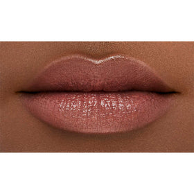 NARS swatch on arm showing peachy-pink shimmer and color-build benefit