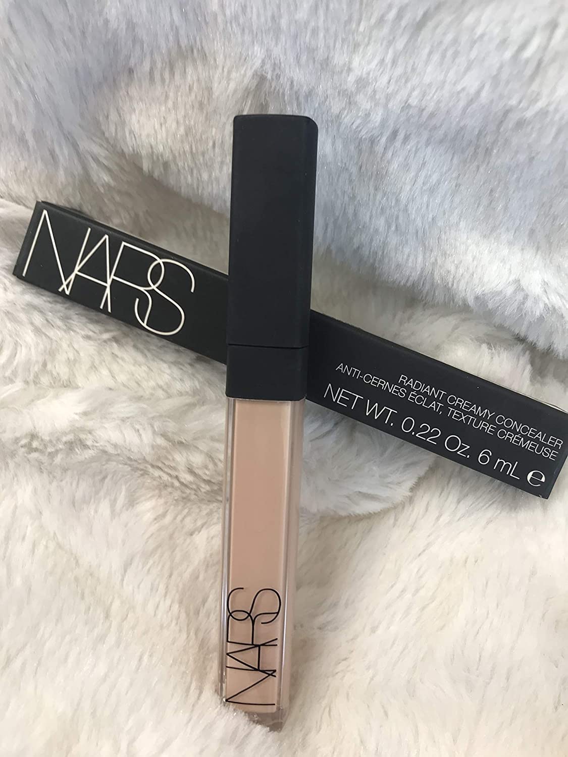 NARS concealer applied on fingertip demonstrating precise application and controlled coverage