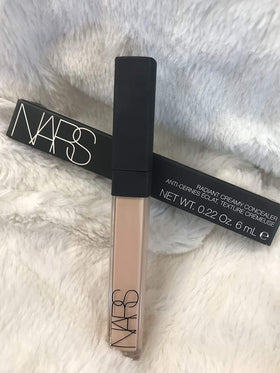 NARS concealer applied on fingertip demonstrating precise application and controlled coverage