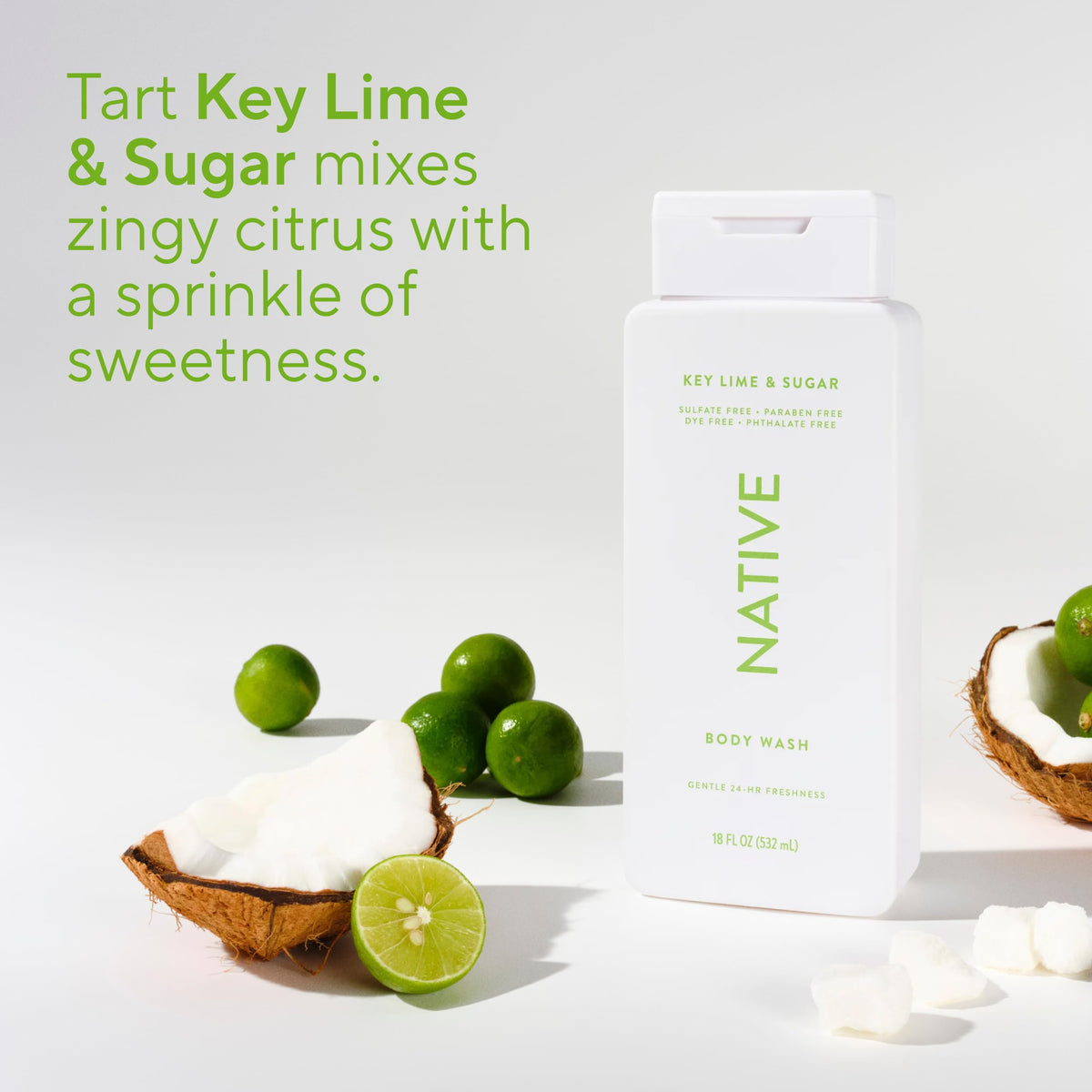 Native bottle beside fresh key limes conveying bright citrus fragrance benefit