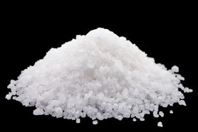 Natural Elephant salt in bathtub being poured for a relaxing mineral soak at home