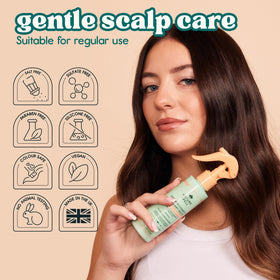 Nature Spell spraying on damp hair for detangling and heat protection