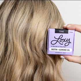 NATURÉL Loxy bar on bathroom shelf in lifestyle setting showing everyday use